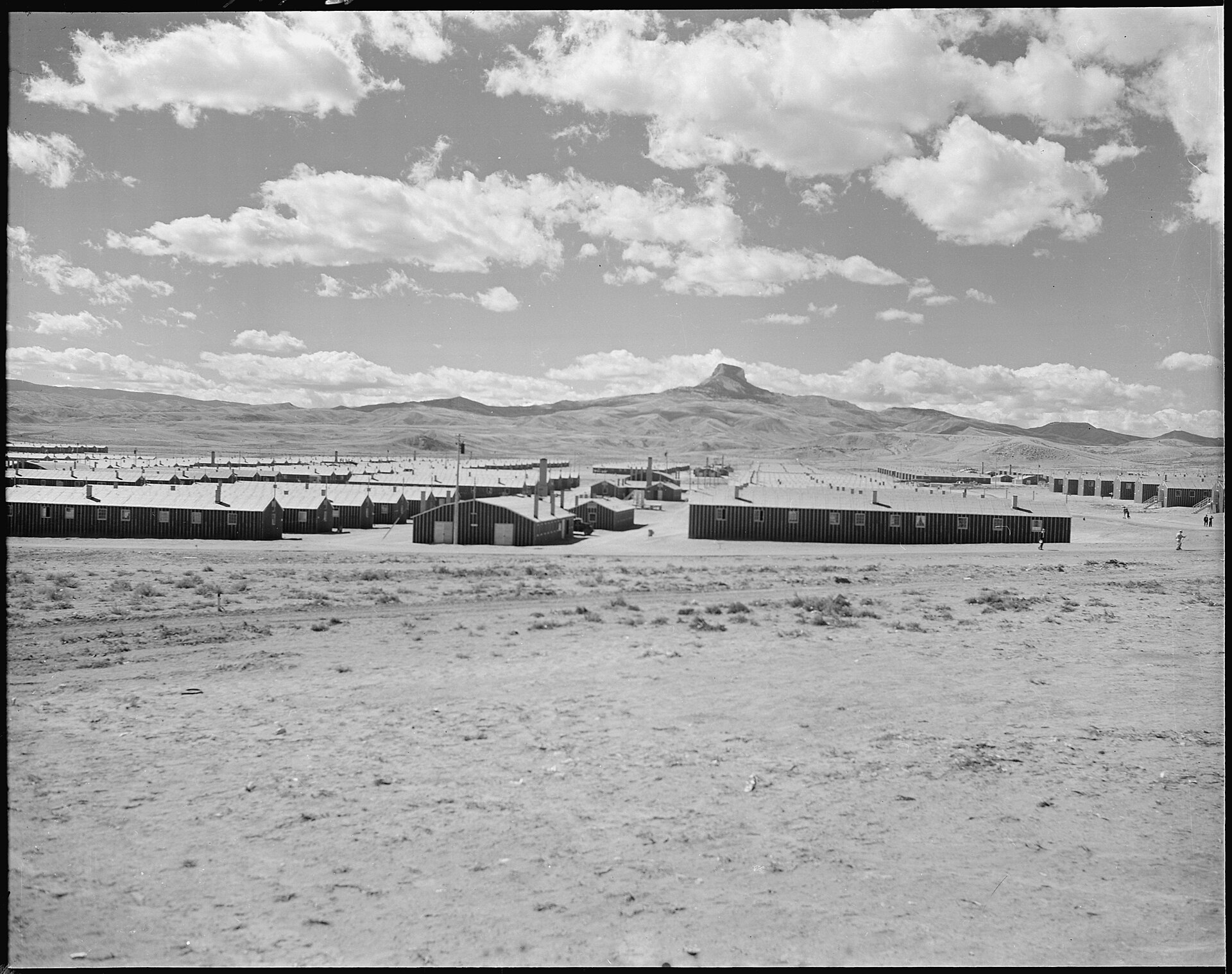 Aerial view of the Heart Mountain internment camp site in northern Wyoming, showing the flat agricultural landscape with Heart Mountain rising in the background.