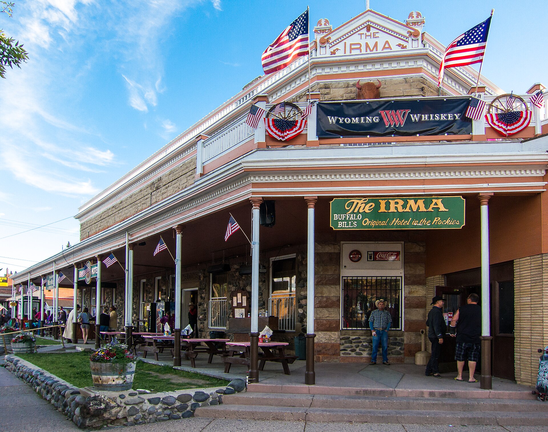The Irma Hotel in Cody, Wyoming, a two-story historic building with a covered porch and Western facade, built by Buffalo Bill in 1902.