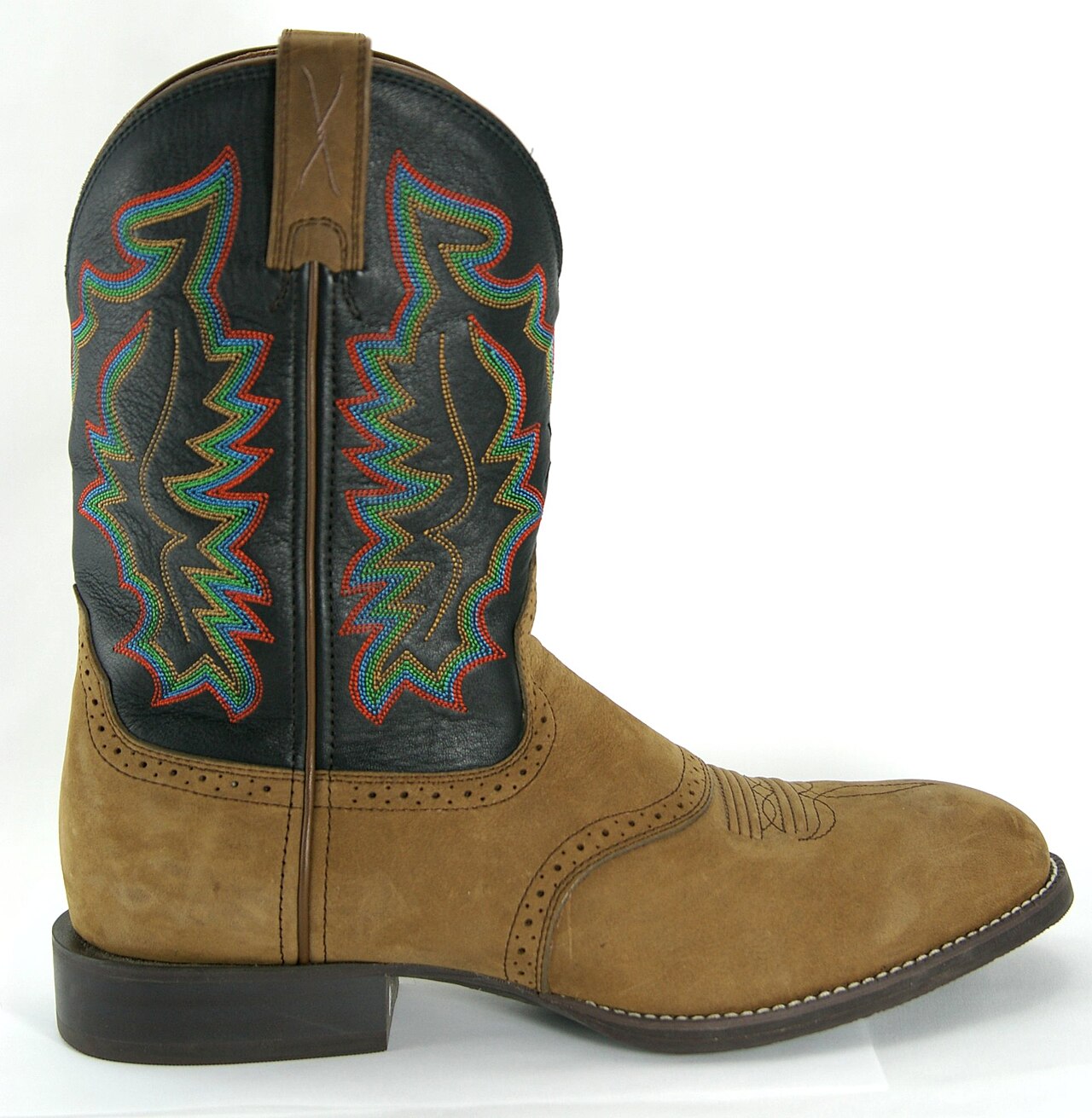 A pair of roper-style Western boots with a low walking heel, round toe, and smooth leather upper, the standard working boot for ranch and sale-yard settings.