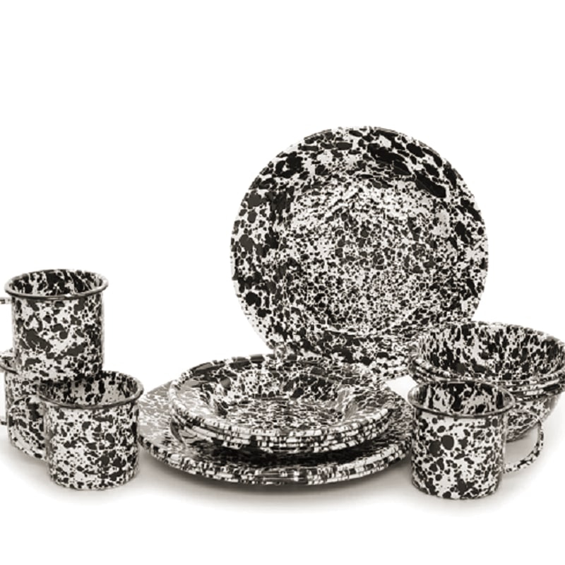 Crow Canyon Home enamelware set with splatter-pattern mugs, plates, and bowls in classic blue speckle