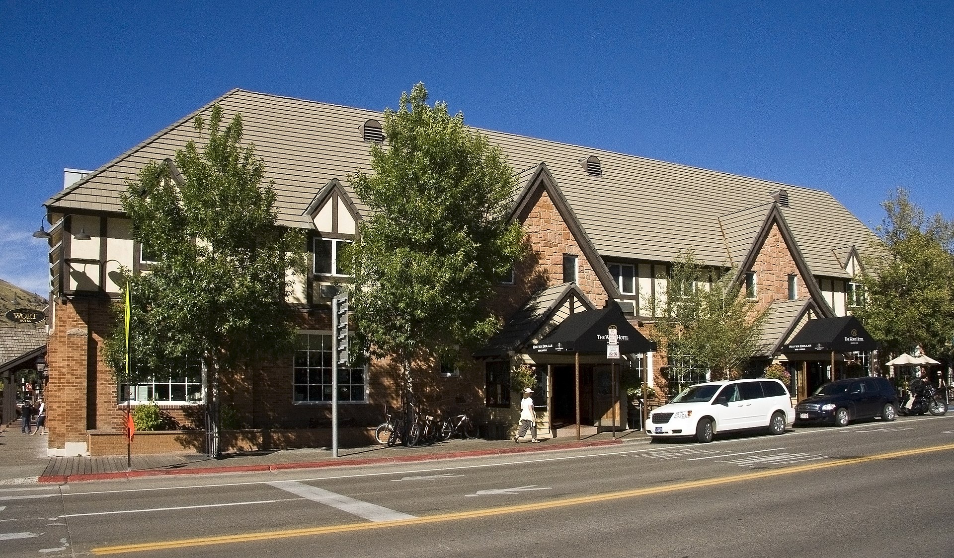 The Wort Hotel on Broadway in downtown Jackson, Wyoming, a two-story brick building with classic Western signage and the Silver Dollar Bar entrance visible at street level.